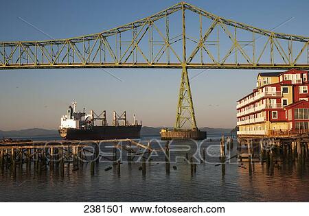 A ship passes the Astoria Riverfront; Astoria, Oregon, United States of America View Large Photo Image Stock Image - A ship passes the Astoria Riverfront; Astoria, Oregon, United States of America. Fotosearch