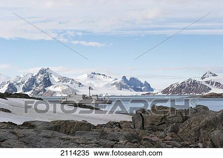 Stock Photography - A Ship Travels Along The Coastline; Antarctica. Fotosearch
