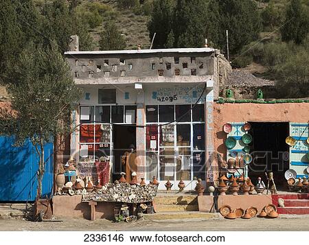 A Shop With Wares On Display Outside And The Vendor Standing In The Doorway; Morocco View Large Photo Image Stock Photograph - A Shop With Wares On Display Outside And The Vendor Standing In The Doorway; Morocco. Fotosearch