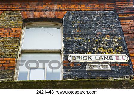 Stock Photo - A sign for Brick Lane on a brick building; London, England. Fotosearch