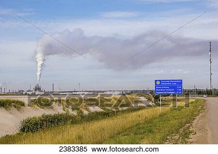 Stock Photography - A sign points tourists to the different Syncrude reclamation areas and tourist points of interest in the oil sands; Fort McMurray, Alberta, Canada. Fotosearch