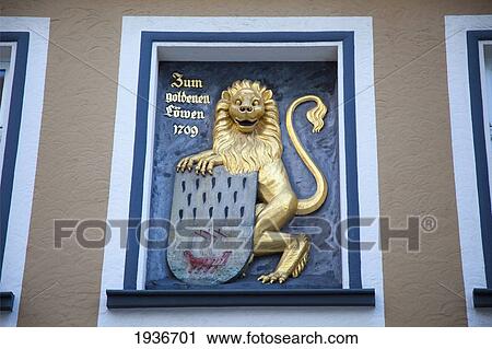 A Sign With A Gold Lion Holding A Crest; Hachenburg Rheinland-Pfalz Germany View Large Photo Image Stock Image - A Sign With A Gold Lion Holding A Crest; Hachenburg Rheinland-Pfalz Germany. Fotosearch