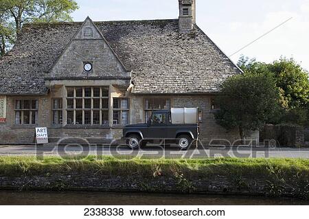 Stock Photo - A Small Truck Parked Outside A Building With A Sign For Art Craft Today; England. Fotosearch