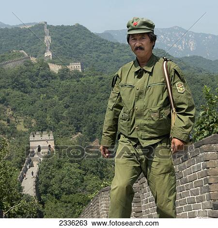 Stock Image - A Soldier In Uniform Stands On The Great Wall Of China; Beijing, China. Fotosearch