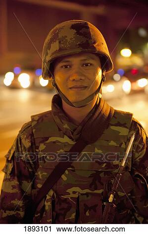 Stock Image - A Soldier On The Street; Bangkok, Thailand. Fotosearch