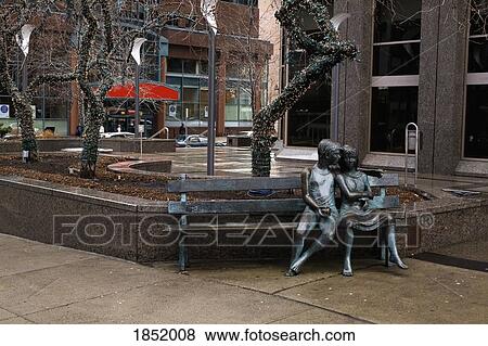 A Statue Of A Couple Sitting On A Bench View Large Photo Image Stock Photo - A Statue Of A Couple Sitting On A Bench. Fotosearch