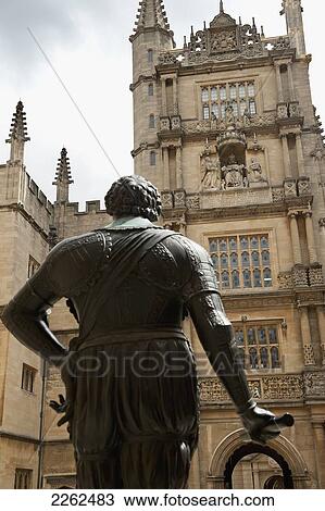 A Statue Of Male Likeness And Tower Of A Building With Ornate Facade; Oxford England View Large Photo Image Stock Image - A Statue Of Male Likeness And Tower Of A Building With Ornate Facade; Oxford England. Fotosearch