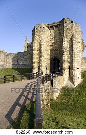 Stock Image - A Stone Building With Bridge And Gate; Northumberland, England. Fotosearch