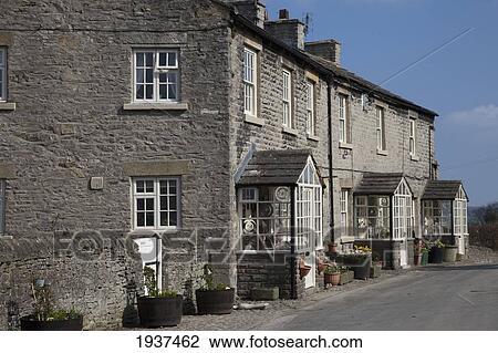 Stock Image - A Stone Building With Three Entrances; Middleham Yorkshire England. Fotosearch