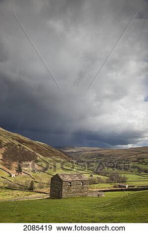 Stock Photo - A Stone Shed In A Field With Storm Clouds Overhead; Swaledale England. Fotosearch