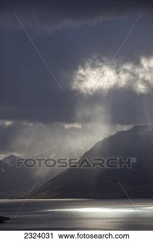 A stormy sky breaks above the Arnarfjorour fjord at sunset; Westfjords, Iceland View Large Photo Image Stock Image - A stormy sky breaks above the Arnarfjorour fjord at sunset; Westfjords, Iceland. Fotosearch