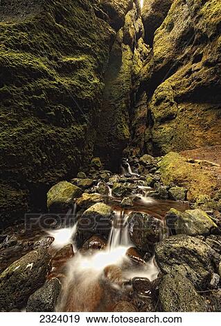 Stock Photo - A stream runs through a slot canyon along the southern coastline of the Snaefellsnes peninsula; Iceland. Fotosearch