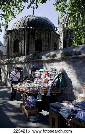 Stock Photography - A street vendor in the shadows of Sehzade Mosque the Western District, Fatih, Istanbul, Turkey. Photo. Fotosearch