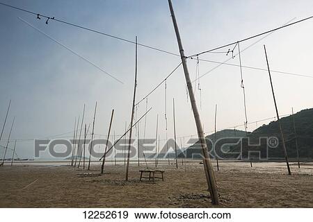 A structure made by posts and ropes to hang fishing nets; Xiapu, Fujian, China View Large Photo Image Stock Photo - A structure made by posts and ropes to hang fishing nets; Xiapu, Fujian, China. Fotosearch