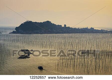 A structure made by posts and ropes to hang fishing nets; Xiapu, Fujian, China View Large Photo Image Stock Photo - A structure made by posts and ropes to hang fishing nets; Xiapu, Fujian, China. Fotosearch