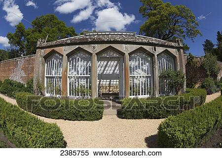 A structure with large windows and a bench at the end of a wall in a landscaped garden; Scottish Borders, Scotland View Large Photo Image Stock Photography - A structure with large windows and a bench at the end of a wall in a landscaped garden; Scottish Borders, Scotland. Fotosearch