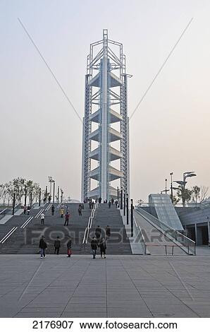 Stock Photo - A Structure With Unique Architecture And Pedestrians On The Steps In Front; Beijing China. Fotosearch