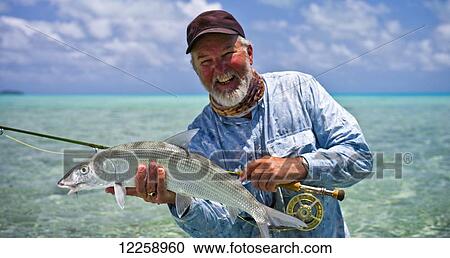 A successful Bone Fisherman; Aitutaki, Cook Islands View Large Photo Image Stock Image - A successful Bone Fisherman; Aitutaki, Cook Islands. Fotosearch