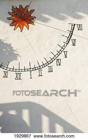 A sundial painted on the wall with shadows cast around it; Binibequer, Menorca, Balearic Islands, Spain View Large Photo Image Stock Photo - A sundial painted on the wall with shadows cast around it; Binibequer, Menorca, Balearic Islands, Spain. Fotosearch