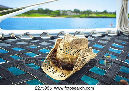 A sunhat on the hammock of a catamaran off the coast of an hawaiian island; Hawaii, United States of America View Large Photo Image Stock Photography - A sunhat on the hammock of a catamaran off the coast of an hawaiian island; Hawaii, United States of America. Fotosearch