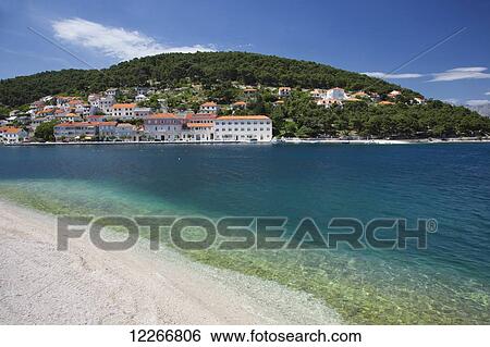 Stock Photograph - A sunny beach; Pucisca, Island of Brac, Croatia. Fotosearch