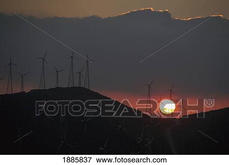 A Sunset Behind Wind Turbines At A Wind Farm On A Mountain Near Tarifa View Large Photo Image Stock Photo - A Sunset Behind Wind Turbines At A Wind Farm On A Mountain Near Tarifa. Fotosearch