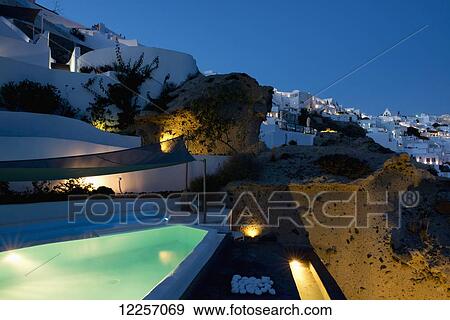 Stock Photo - A swimming pool on a terrace at dusk; Oia, Santorini, Cyclades, Greek Islands, Greece. Fotosearch