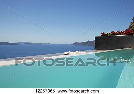 A swimming pooling overlooking the caldera; Oia, Santorini, Cyclades, Greek Islands, Greece View Large Photo Image Stock Photography - A swimming pooling overlooking the caldera; Oia, Santorini, Cyclades, Greek Islands, Greece. Fotosearch