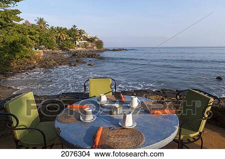 A Table Set For A Meal Along The Water's Edge; Sayulita Mexico View Large Photo Image Picture - A Table Set For A Meal Along The Water's Edge; Sayulita Mexico. Fotosearch