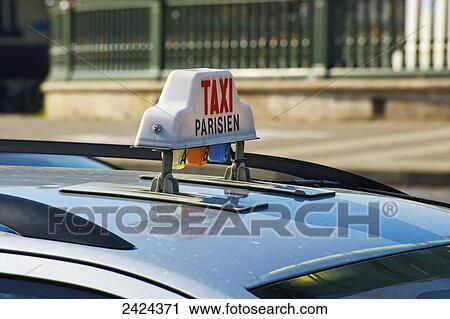 A taxi sign on the roof of a vehicle; Paris, France View Large Photo Image Stock Image - A taxi sign on the roof of a vehicle; Paris, France. Fotosearch