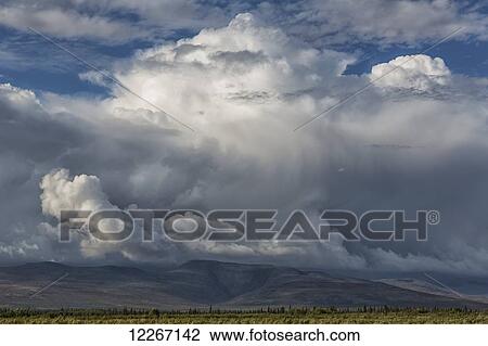 Stock Image - A thunderstorm builds up over the Northern Yukon, near Old Crow; Yukon, Canada. Fotosearch