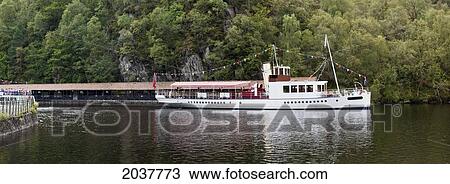 Stock Image - A Tour Boat Sails Down Loch Katrine; Stirling Scotland. Fotosearch