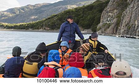A tour guide leads a boat tour, Torres del Paine National Park; Torres del Paine, Magallanes and Antartica Chilena Region, Chile View Large Photo Image Stock Photograph - A tour guide leads a boat tour, Torres del Paine National Park; Torres del Paine, Magallanes and Antartica Chilena Region, Chile. Fotosearch