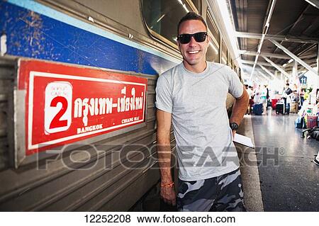 A tourist gets ready to board a train out of Bangkok's Hualamphong Station (Krungthep); Bangkok, Thailand View Large Photo Image Stock Photo - A tourist gets ready to board a train out of Bangkok's Hualamphong Station (Krungthep); Bangkok, Thailand. Fotosearch