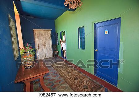 Stock Photo - A Tourist Looks Out The Door Of Her Room Into The Hallway Of Hotel California; Todos Santos Baja California Sur Mexico. Fotosearch
