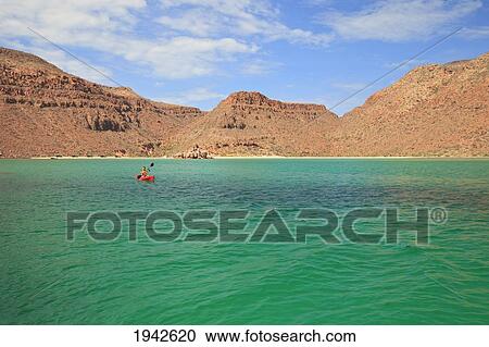Stock Image - A Tourist Paddles A Boat Off Espiritu Santo Island; La Paz Baja California Mexico. Fotosearch
