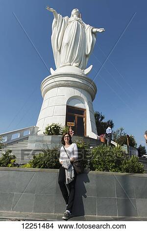 A tourist stands in front of the Virgin Mary statue on San Cristobal Hill; Santiago, Santiago Metropolitan Region, Chile View Large Photo Image Picture - A tourist stands in front of the Virgin Mary statue on San Cristobal Hill; Santiago, Santiago Metropolitan Region, Chile. Fotosearch