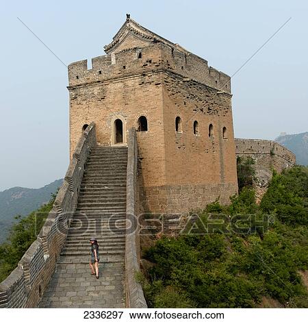 Stock Photo - A Tourist Walking Up The Steps On The Great Wall Of China; Beijing, China. Fotosearch