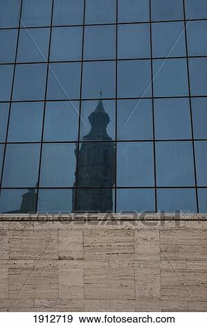 Stock Photo - A Tower Reflected In The Mirror Windows Of Another Building; Spain. Fotosearch