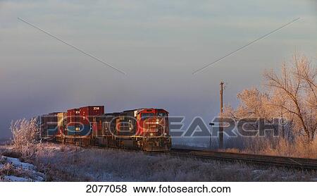 A Train Travels On The Tracks Beside Frozen Ground; Parkland County Alberta Canada View Large Photo Image Stock Photo - A Train Travels On The Tracks Beside Frozen Ground; Parkland County Alberta Canada. Fotosearch