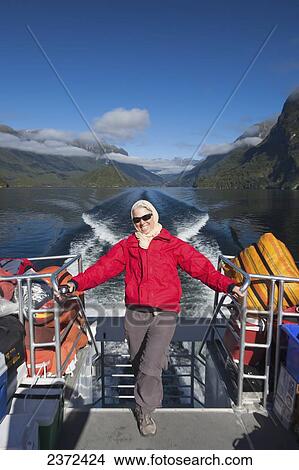 Picture - A Traveler Enjoying A Scenic Boat Cruise On Lake Manapouri To Doubtful Sound; New Zealand. Fotosearch