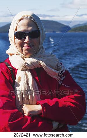 Stock Image - A Traveler Enjoying A Scenic Boat Cruise On Lake Manapouri To Doubtful Sound; New Zealand. Fotosearch