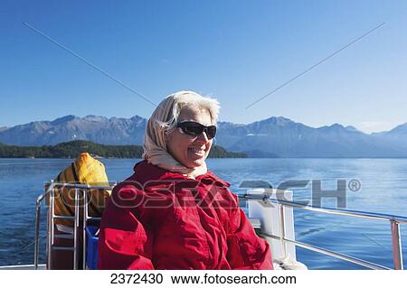 A Traveler Enjoying A Scenic Boat Cruise On Lake Manapouri To Doubtful Sound; New Zealand View Large Photo Image Stock Image - A Traveler Enjoying A Scenic Boat Cruise On Lake Manapouri To Doubtful Sound; New Zealand. Fotosearch