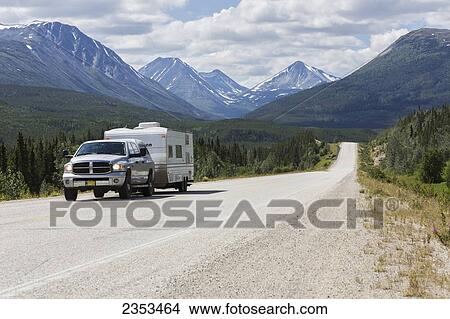 A Truck And Camper Heading South To Alaska On The Alaska Highway Near Rancheria; Yukon, Canada View Large Photo Image Picture - A Truck And Camper Heading South To Alaska On The Alaska Highway Near Rancheria; Yukon, Canada. Fotosearch