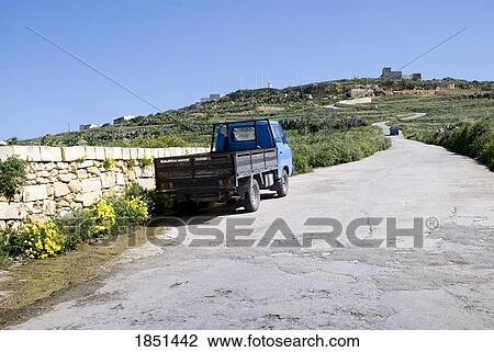 Stock Image - A Truck Parked On The Side Of A Rural Road. Fotosearch