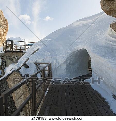 A Tunnel Through A Pile Of Snow On A Wooden Walkway; Chamonix-Mont-Blanc Rhone-Alpes France View Large Photo Image Stock Image - A Tunnel Through A Pile Of Snow On A Wooden Walkway; Chamonix-Mont-Blanc Rhone-Alpes France. Fotosearch