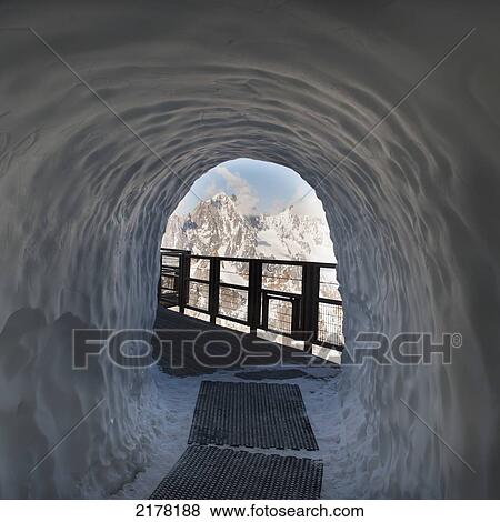 Stock Photo - A Tunnel Through A Pile Of Snow On A Walkway; Chamonix-Mont-Blanc Rhone-Alpes France. Fotosearch