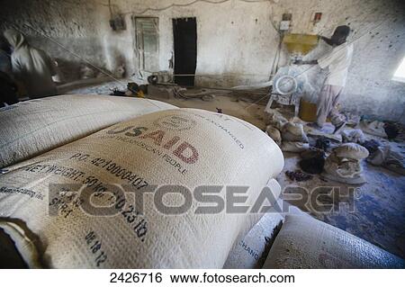 Stock Photograph - A US AID bag of grain waiting to be ground in a mill; Harar, Ethiopia. Fotosearch