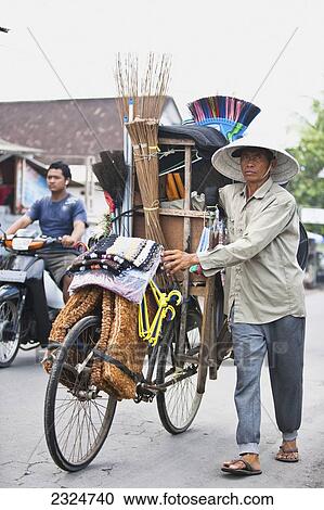 Stock Image - A Vendor Has His Store On His Bike, Pemogan, Bali, Indonesia. Fotosearch