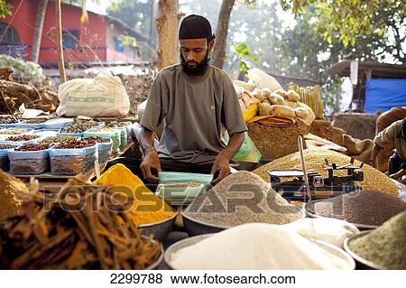 A vendor sits amongst his dried produce in Chaudi Market, Chaudi, Goa, India. View Large Photo Image Stock Photo - A vendor sits amongst his dried produce in Chaudi Market, Chaudi, Goa, India.. Fotosearch